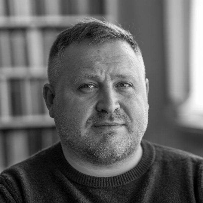 A man with a round, chubby face sporting short haircut