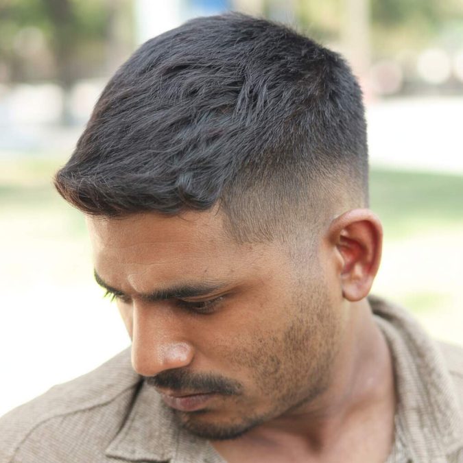 An Indian man sporting a short, textured crop haircut