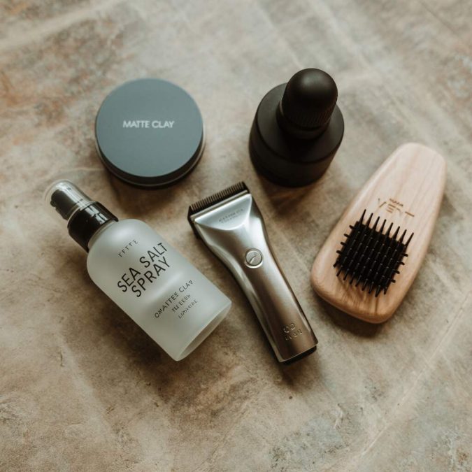 Flat-lay-of-mens-hair-styling-tools-and-products-for-maintaining-fades