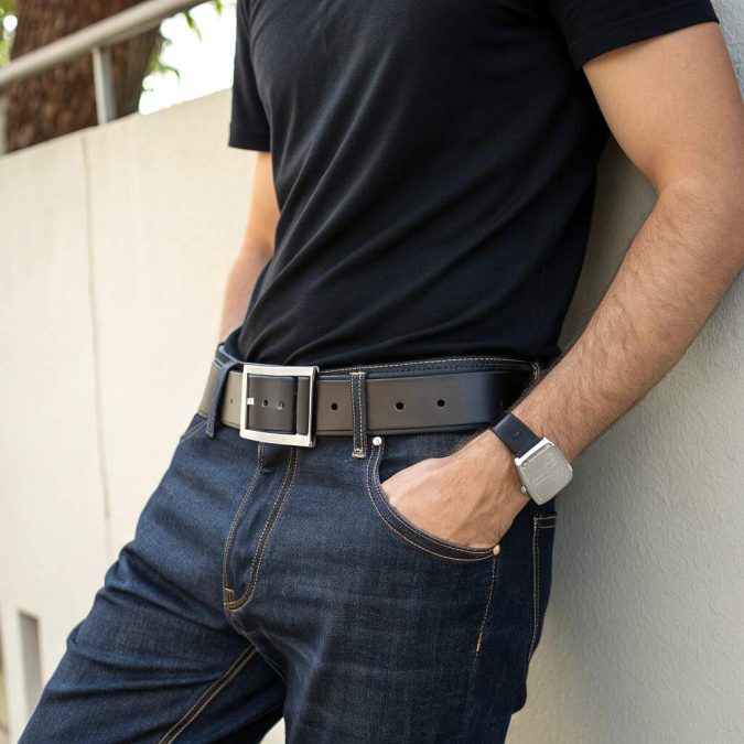 casual men’s outfit with dark jeans and black leather statement belt, matte silver buckle, black tee