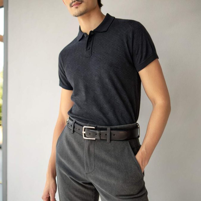 dressy casual men’s outfit with charcoal trousers and black leather statement belt, low-profile buckle