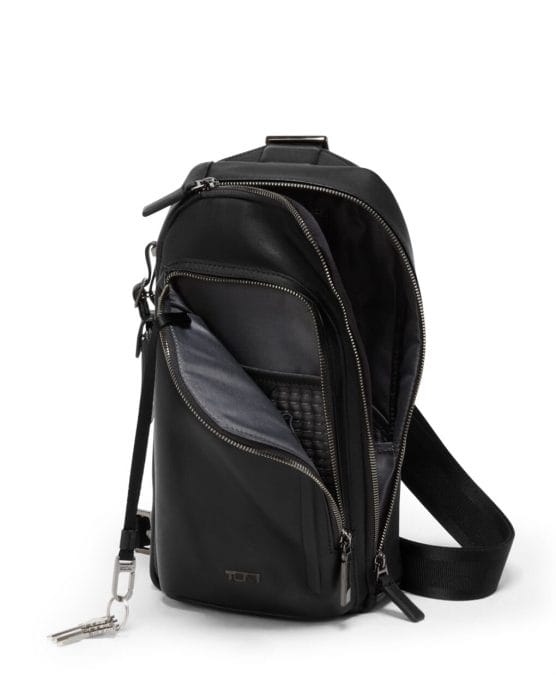 Tumi travel bag combining leather and performance fabric.