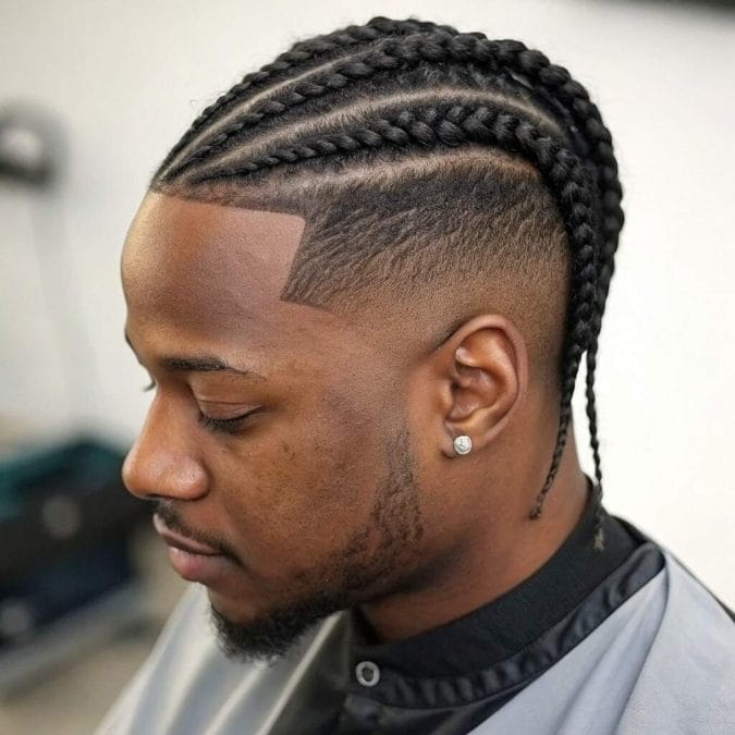 Box braids paired with a taper fade, blending protective styling with clean edges.