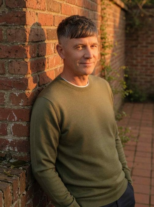 Man over 40 with a French crop haircut and textured fringe.