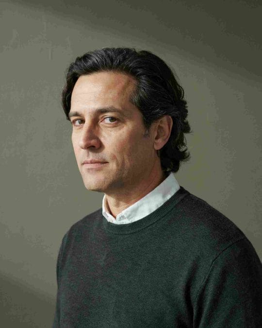Man over 40 with medium textured flow in a minimalist interior.