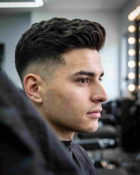 Wavy mid fade with a sharp blend and textured top.