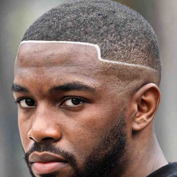 Buzz cut with a sharp shape up and clean beard, showing a classic Haircut Ideas for Black Men style with defined edges.