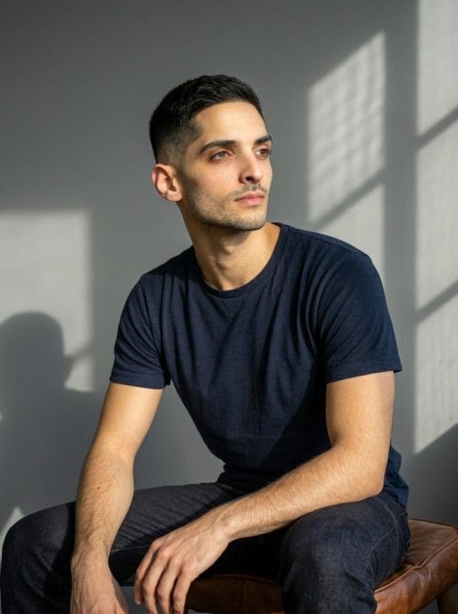 Man with a low taper crew cut and lightly textured top.