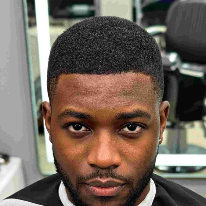 Even all-over haircut with uniform length and clean edges for Black men.
