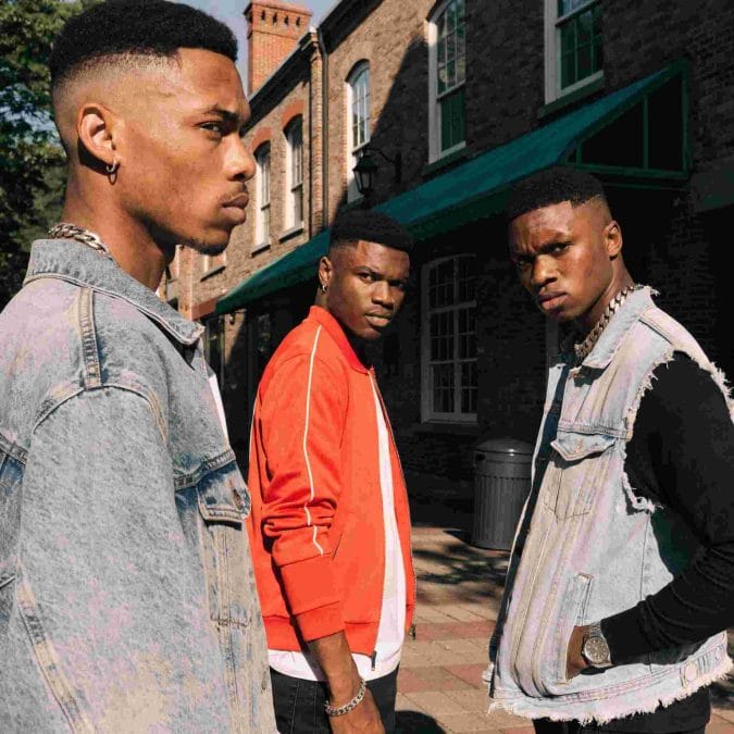 Black man wearing a flat top fade haircut with clean sides and structured height.