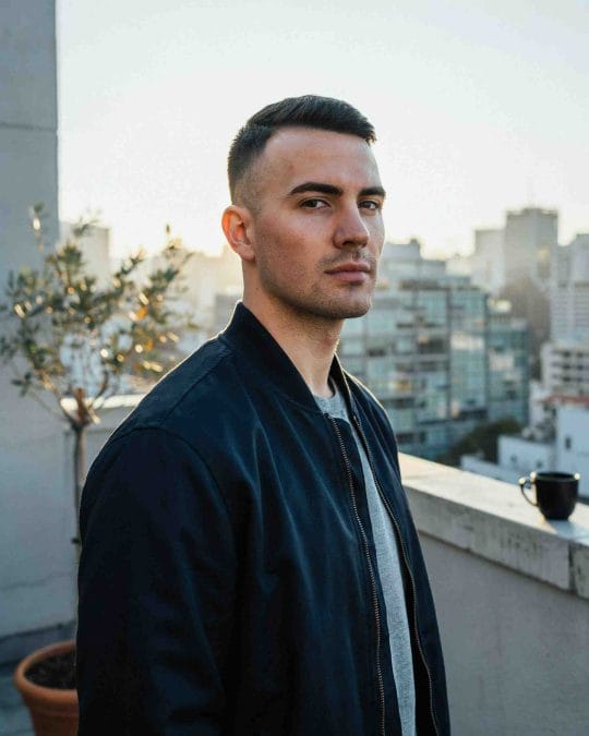 Man with a high fade crew cut and textured top.