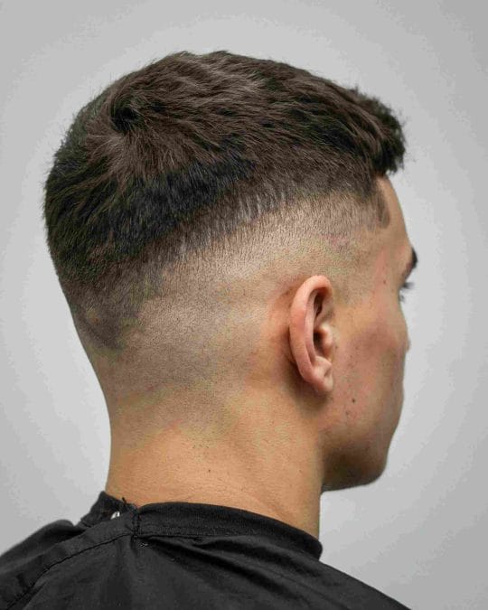 Man with a low fade crew cut and clean barber finish.