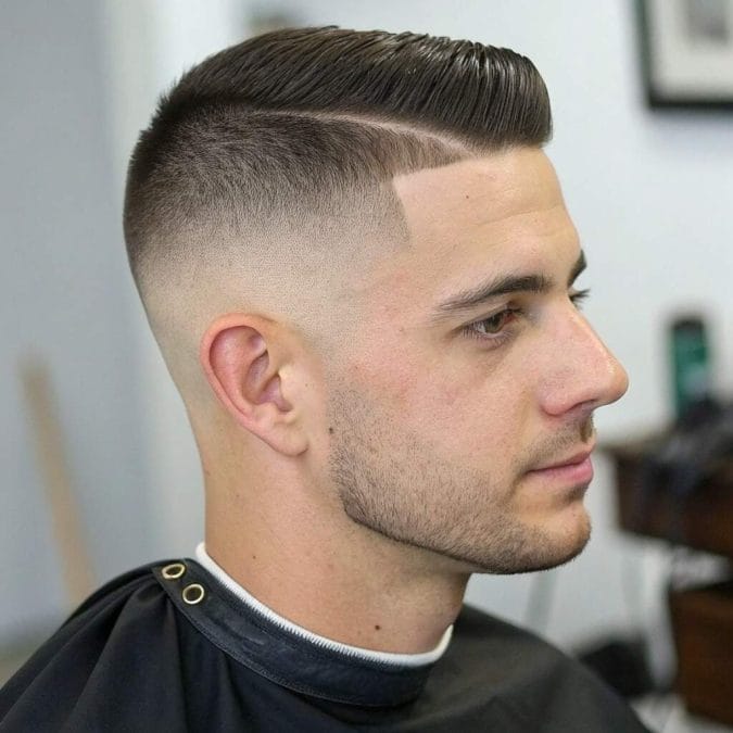 Skin fade for straight hair with ultra-short sides that blend into a longer textured top.