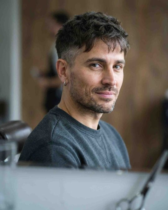 Messy textured crop haircut with short faded sides.