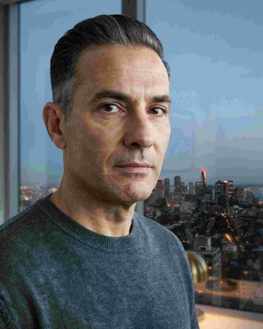 Mature man with a slicked-back taper haircut and faded sides.