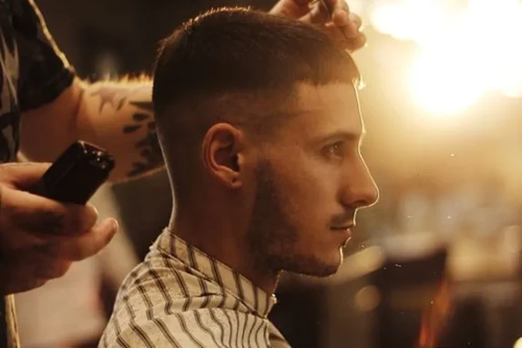Products for thick hair: a man receiving a stylish haircut in a barbershop.