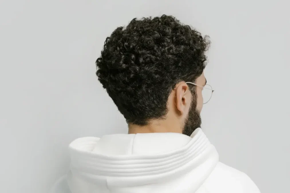 Back view of a man with curly hair