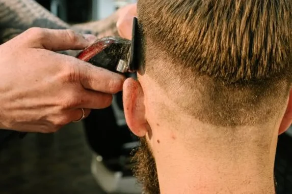 Haircuts for minimalist style: a barber giving a stylish haircut in a modern barbershop.